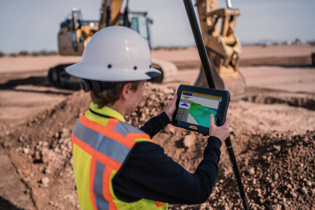 Person at construction site looking at a tablet